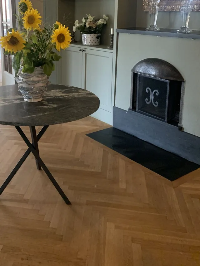 Hallway with sunflowers and an open fireplace in the home in Östermalm